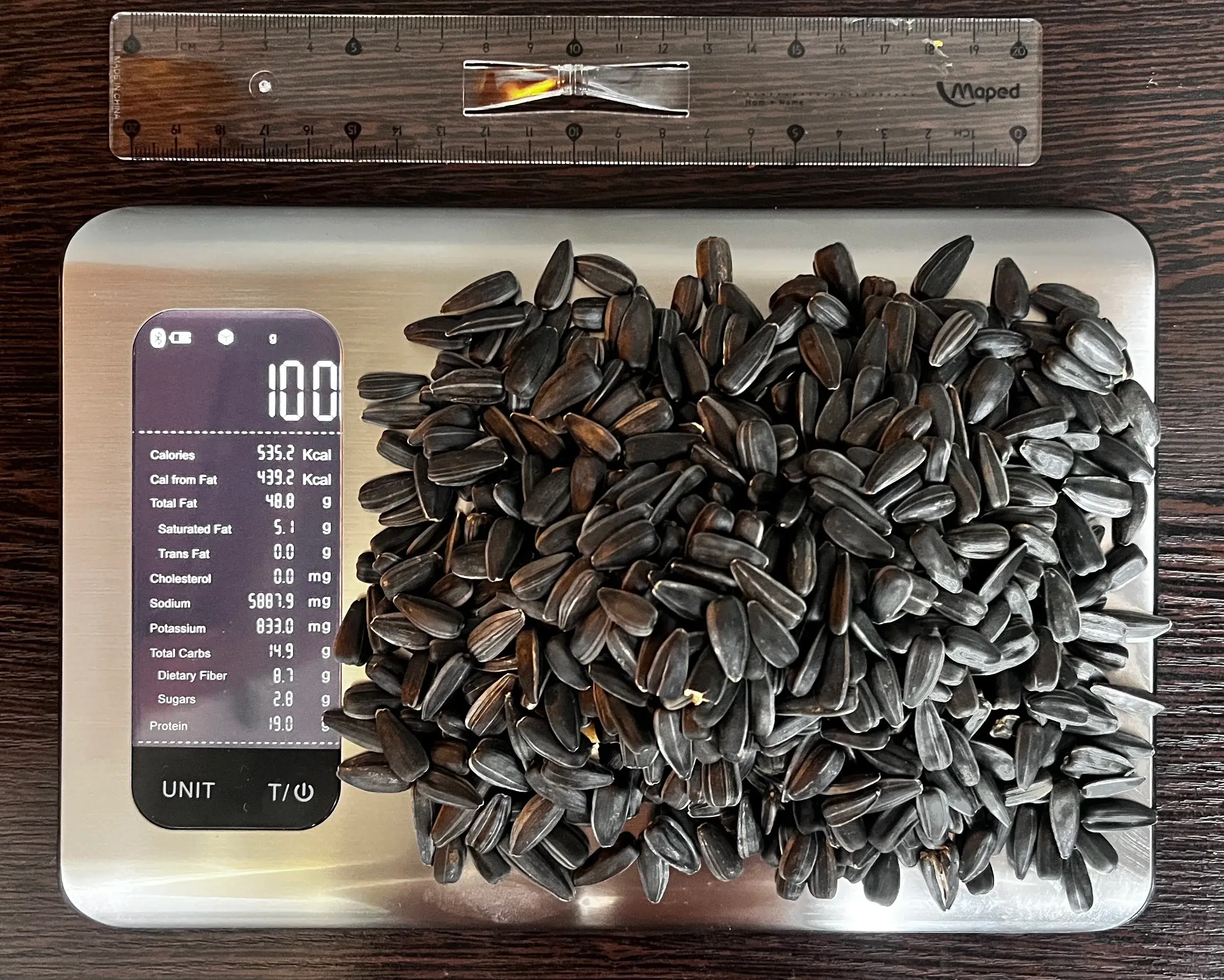 535 Calories or 100 Grams of Sunflower Seeds on scale