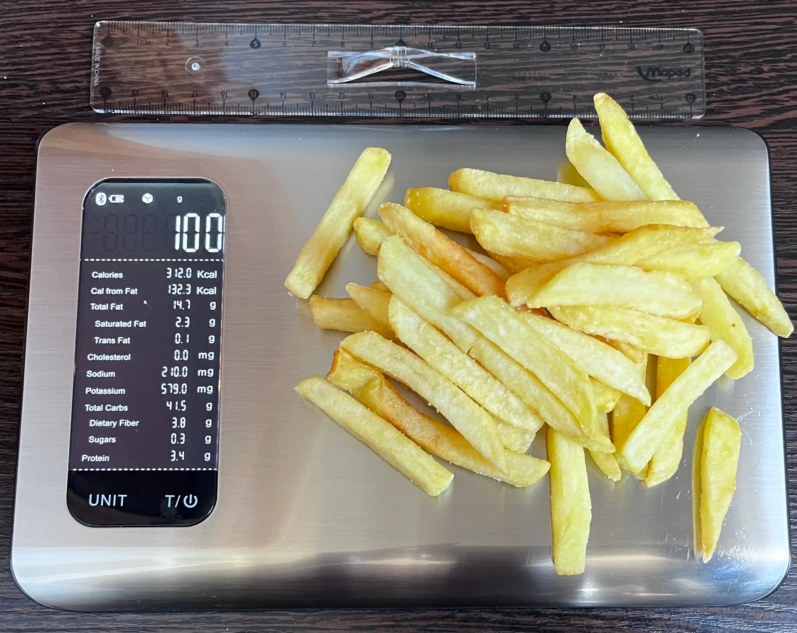 312 Calories or 100 Grams of French Fries on scale